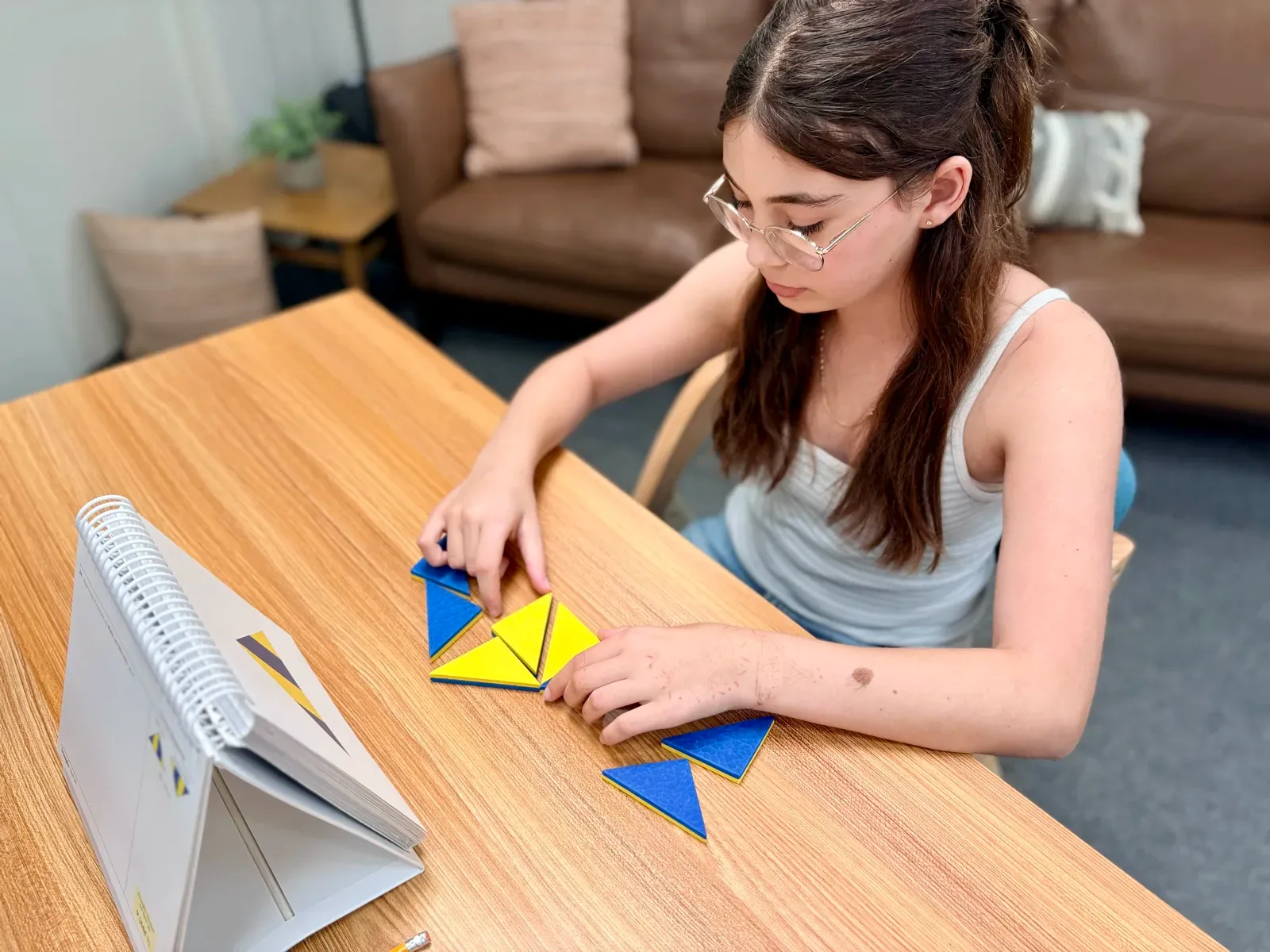 A student assembling a two-color shape puzzle during testing