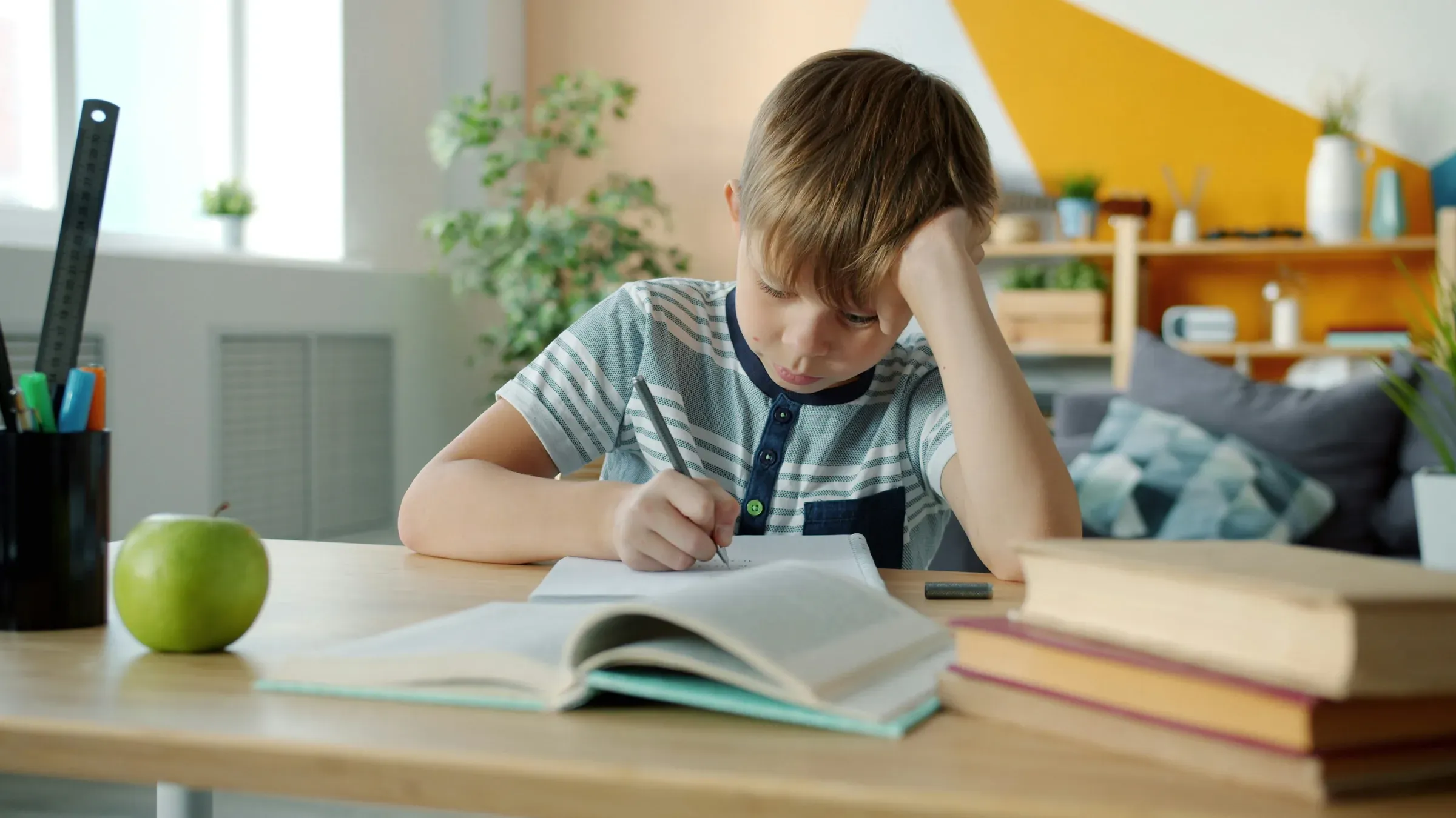 A young student concentrating on schoolwork at a desk