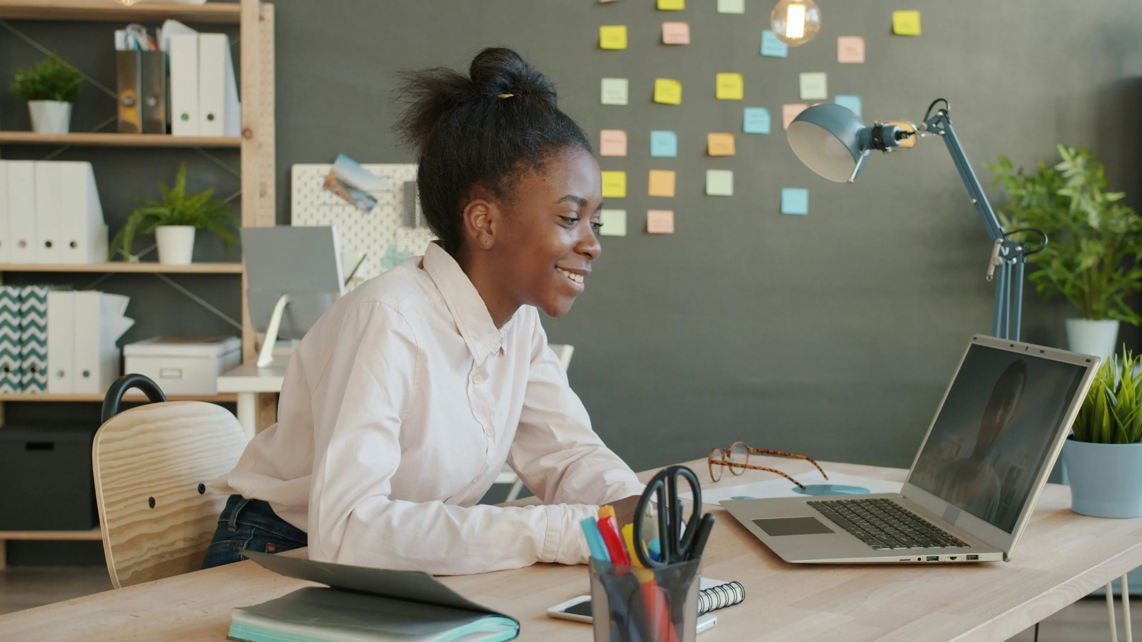 A student on a video call at a desk at home