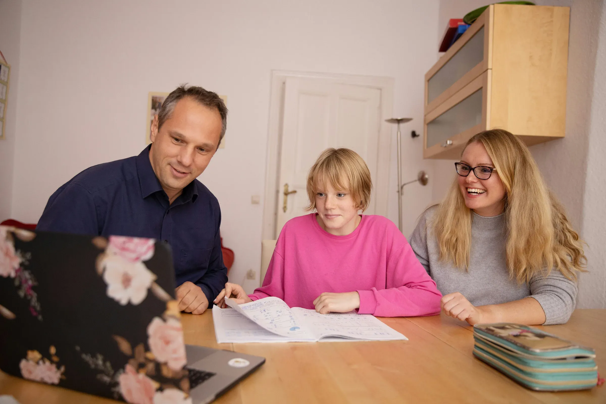 A family reviewing schoolwork together at home